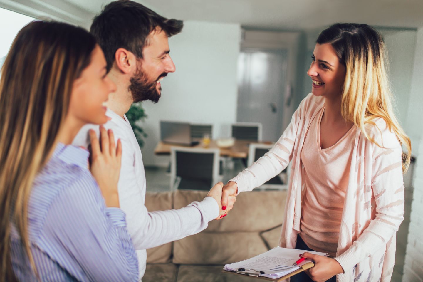 A confident real estate agent closing a sale on a home