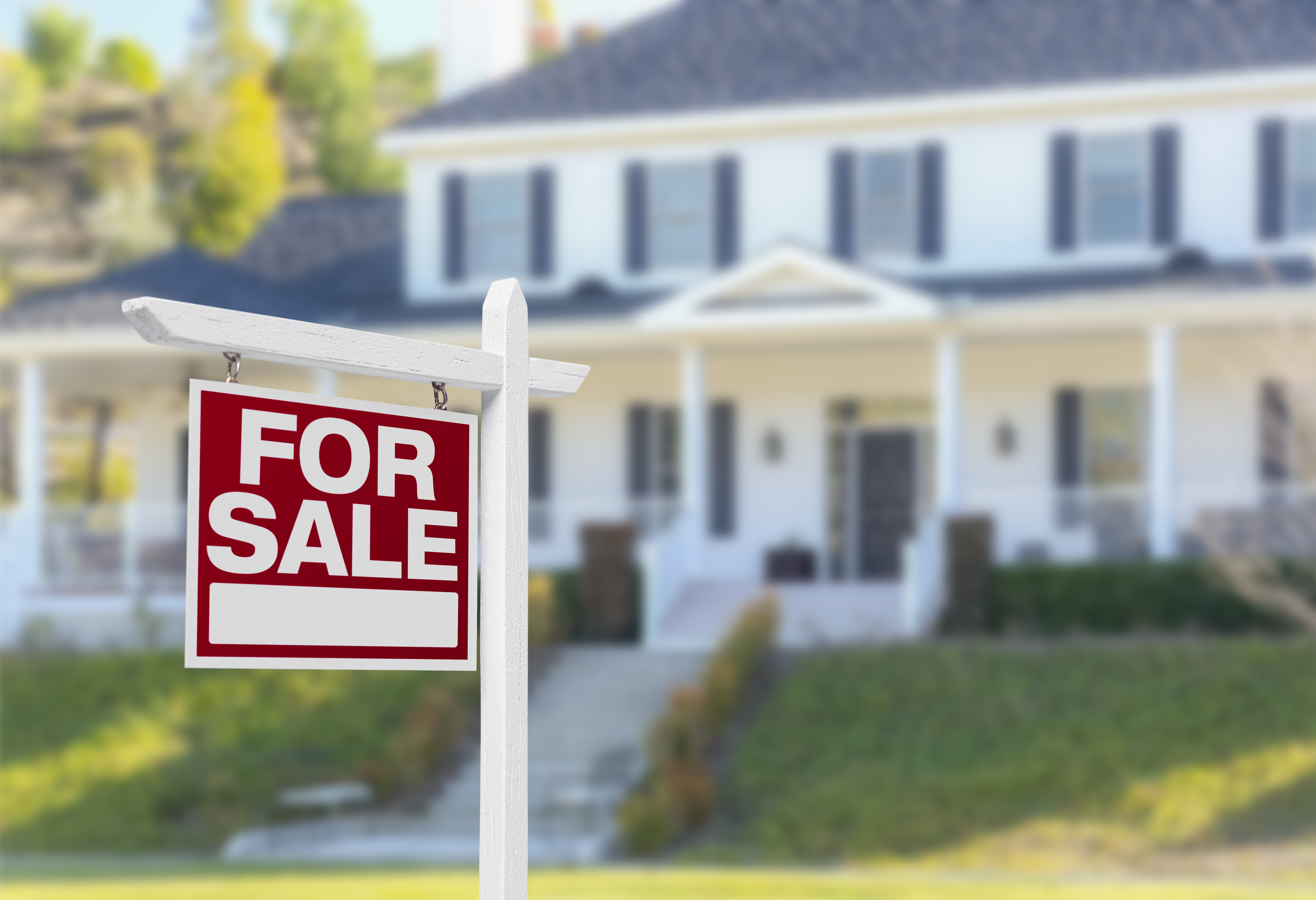 For sale sign in front of home