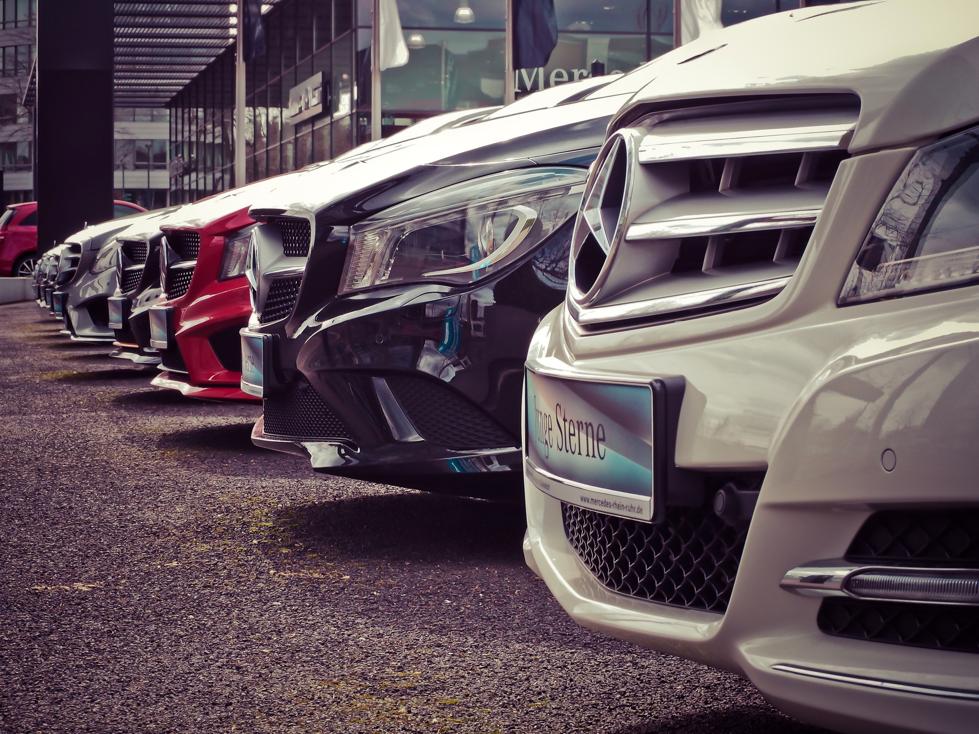 Line of new mercedes benz cars at car dealership