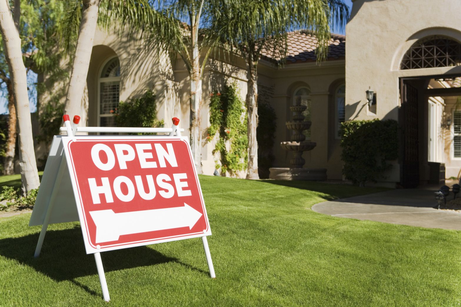 Open house sign on front lawn outside of house