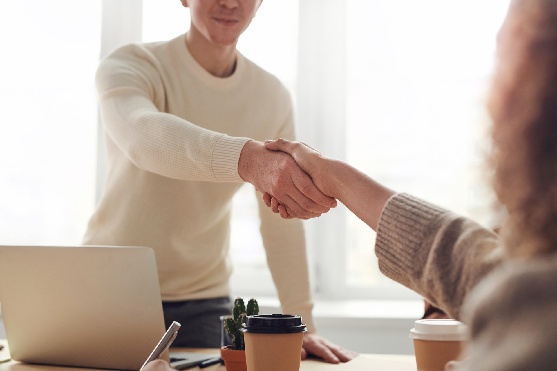 Real estate agent shaking clients hand