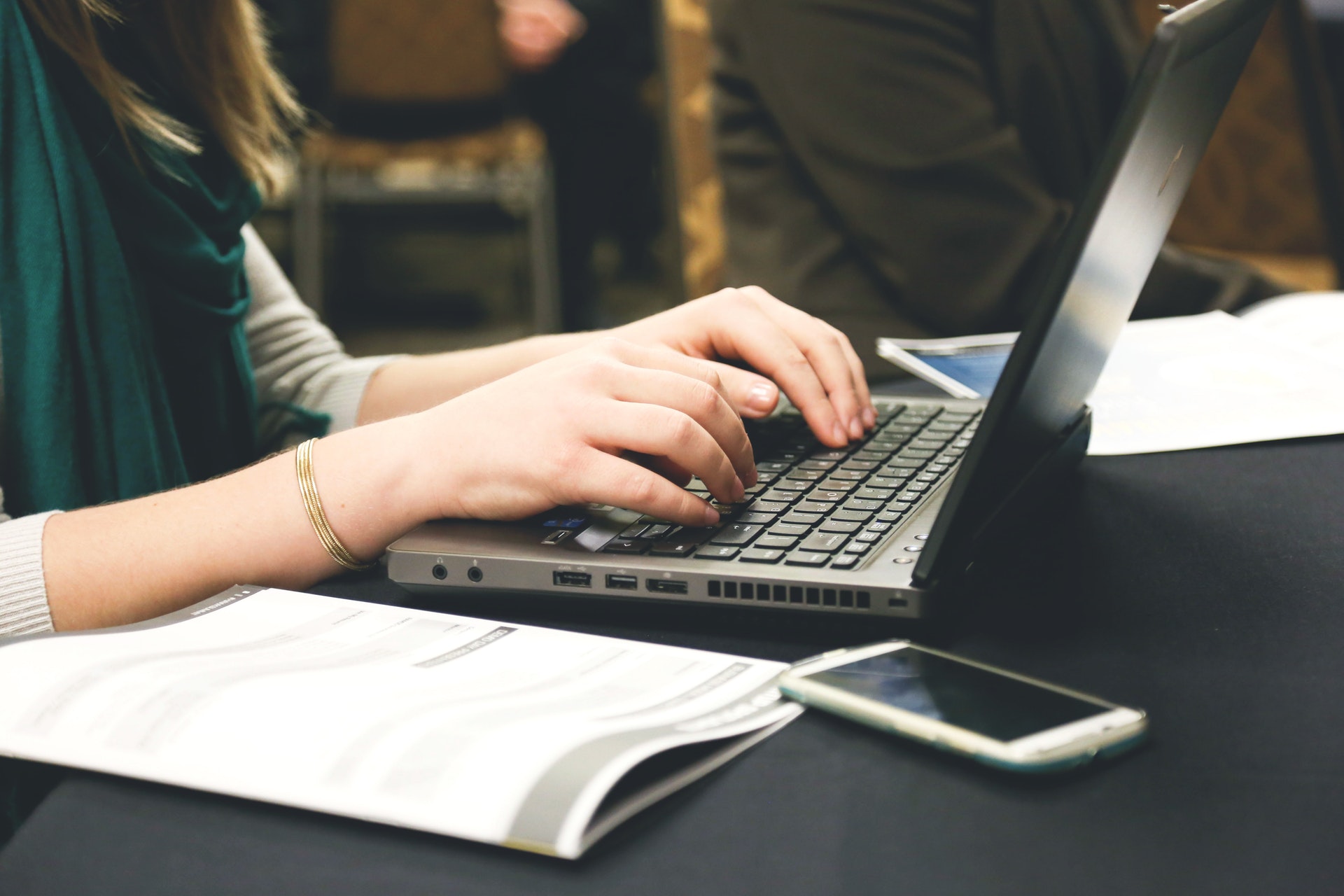 Real estate agent typing ad copy on her laptop