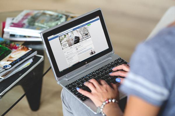 Real estate agent writing a new facebook post