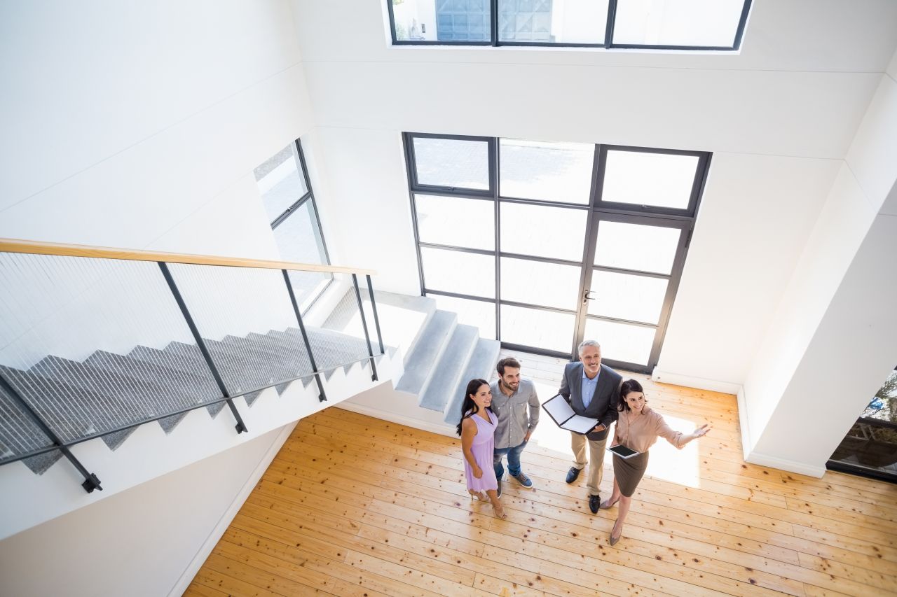 Real estate agents showing house to first time home buyers