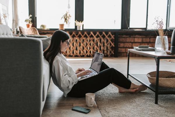 Unlicensed real estate assistant working on her laptop